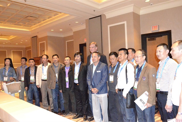 Chris Brown, executive editor of Auto Rental News, poses with the Chinese car rental delegation.